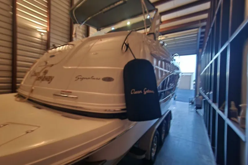Slide: The Image of 2006 Chaparral Signature 290 boat on a trailer under a bridge. - 28