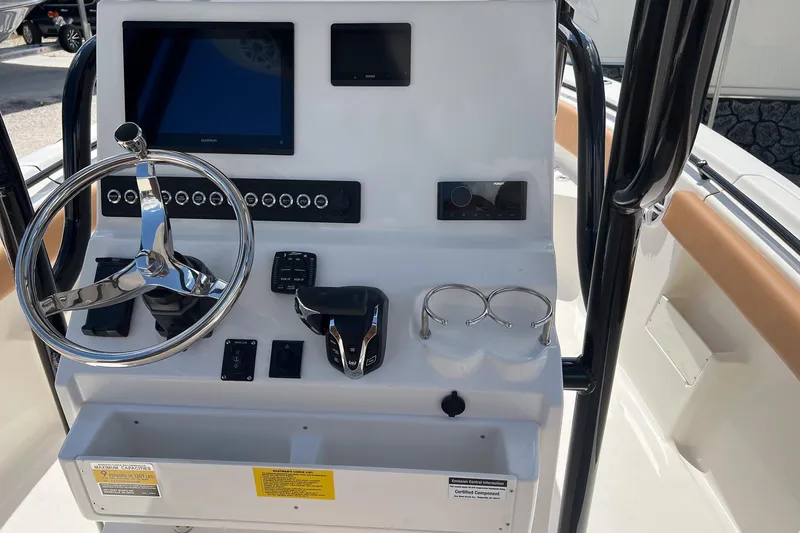 Slide: The Image of 2026 Key West 239 FS boat dashboard with steering wheel and electronic controls. - 10