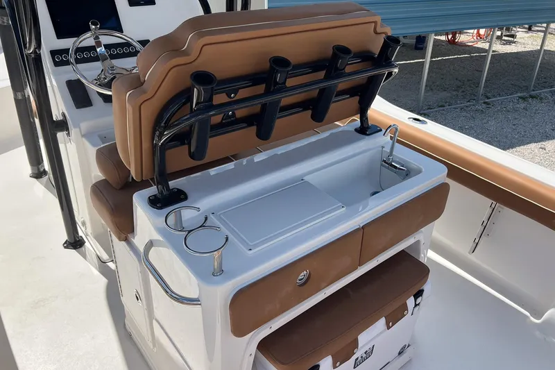 Slide: The Image of 2026 Key West 239 FS boat interior with seating, rod holders, and sink. - 12