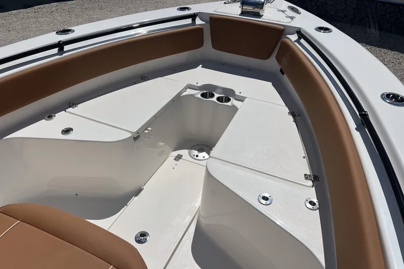 Slide: The Image of 2026 Key West 239 FS boat interior with tan seating and cup holders. - 16