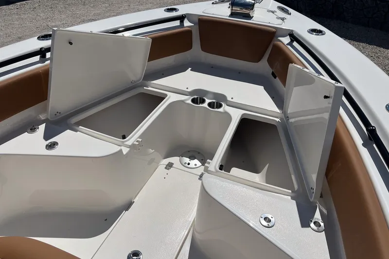 Slide: The Image of 2026 Key West 239 FS boat interior with open storage compartments and cup holders. - 18