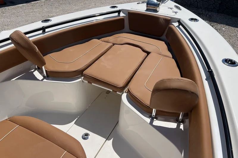 Slide: The Image of 2026 Key West 239 FS boat interior with tan cushioned seating and sleek design. - 19