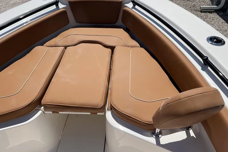 Slide: The Image of 2026 Key West 239 FS boat with tan cushioned seating in the bow area. - 21
