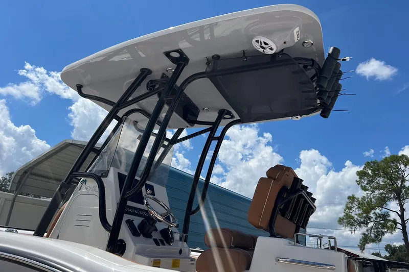 Slide: The Image of 2026 Key West 239 FS boat with T-top and seating, under a clear blue sky. - 26