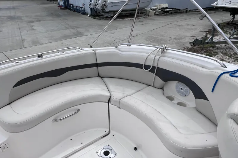 Slide: The Image of 2004 Chaparral Sunesta 254 boat interior with white seating and cup holders. - 10