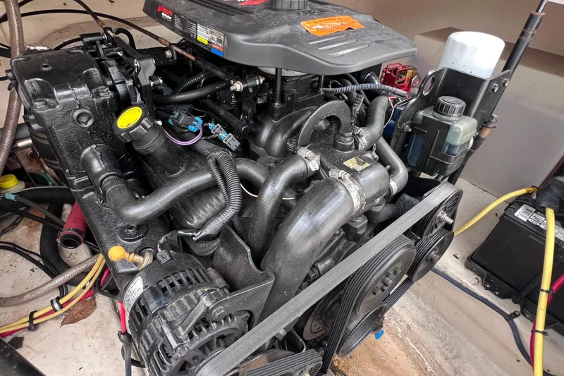 Slide: The Image of Engine compartment of a 2004 Chaparral Sunesta 254 boat, showcasing detailed components. - 21