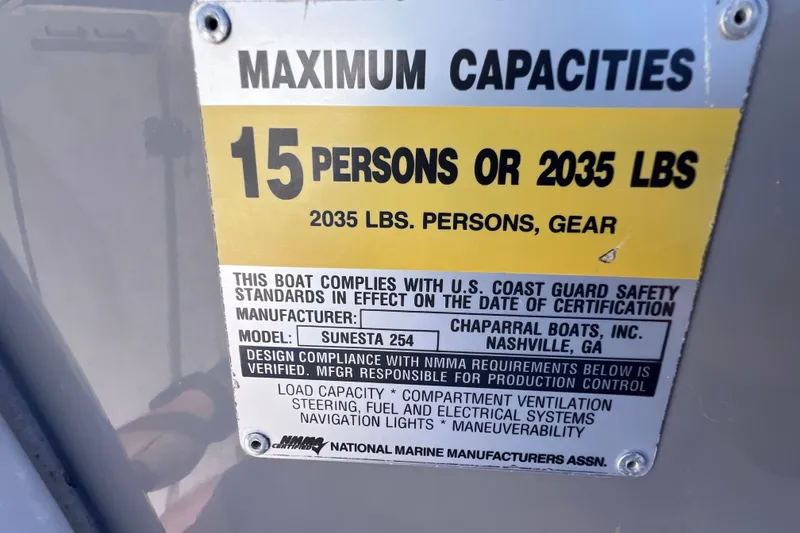 Slide: The Image of 2004 Chaparral Sunesta 254 capacity label, 15 persons or 2035 lbs, safety compliance. - 29