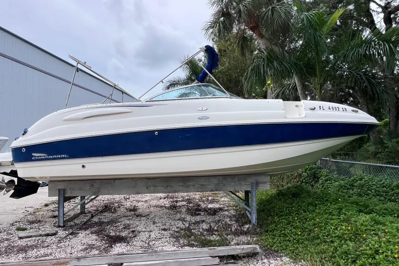 Slide: The Image of 2004 Chaparral Sunesta 254 boat on a stand, surrounded by palm trees. - 3