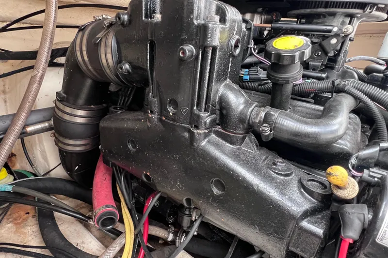 Slide: The Image of Engine compartment of a 2004 Chaparral Sunesta 254 boat, showing hoses and components. - 33