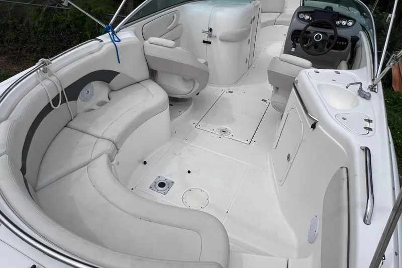 Slide: The Image of 2004 Chaparral Sunesta 254 boat interior with spacious seating and modern dashboard. - 9