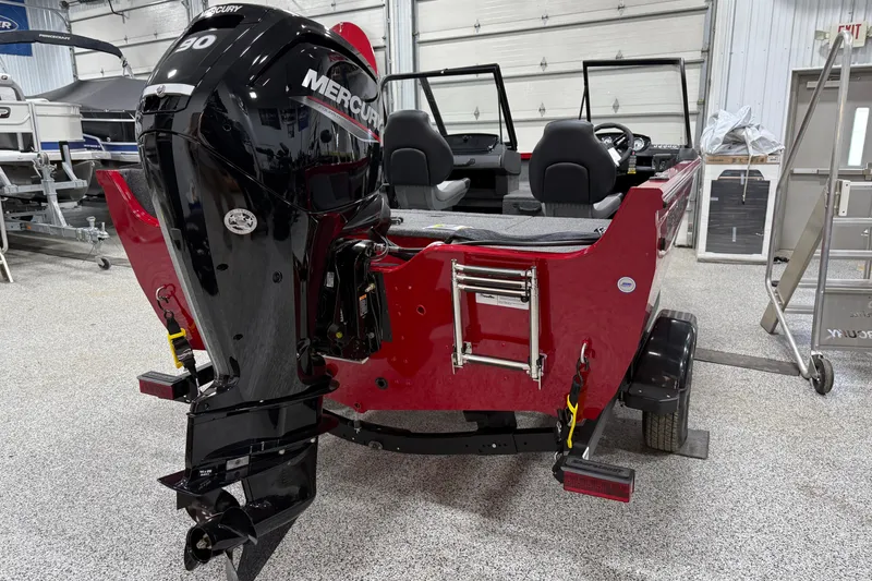 Slide: The Image of 2025 Crestliner 1650 Hawk boat with Mercury engine in a showroom. - 2