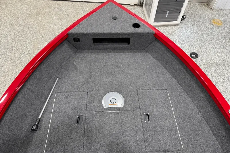 Slide: The Image of 2025 Crestliner 1650 Hawk boat interior with red trim and carpeted deck. - 3