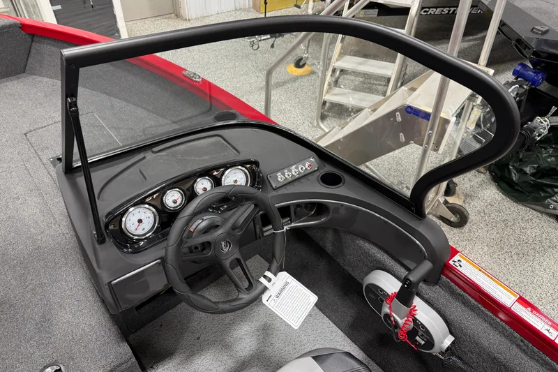 Slide: The Image of 2025 Crestliner 1650 Hawk boat dashboard with steering wheel and gauges. - 7