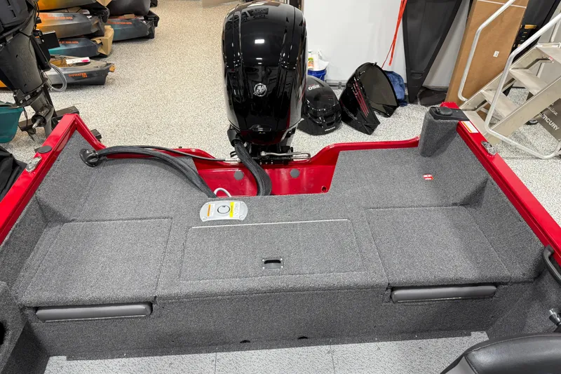 Slide: The Image of 2025 Crestliner 1650 Hawk boat interior with motor, red and gray design. - 9