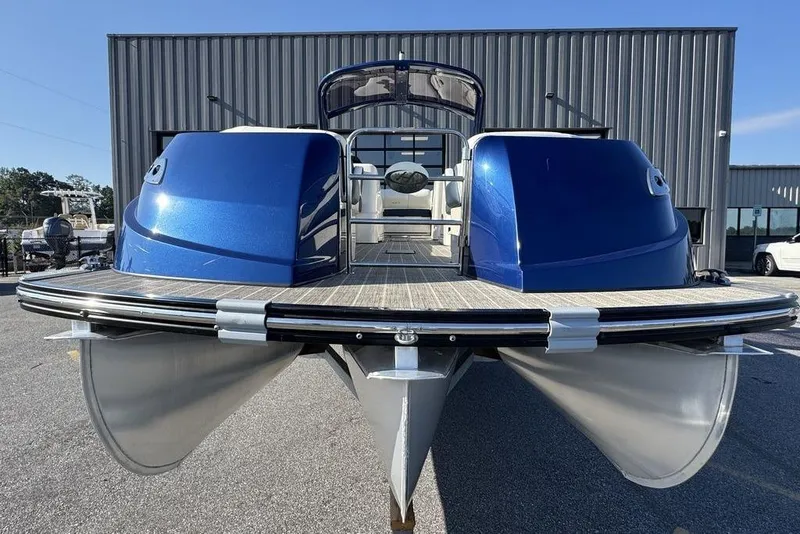 Slide: The Image of 2021 Harris Crowne SL 270 Twin Engine pontoon boat, blue exterior, docked outdoors. - 10