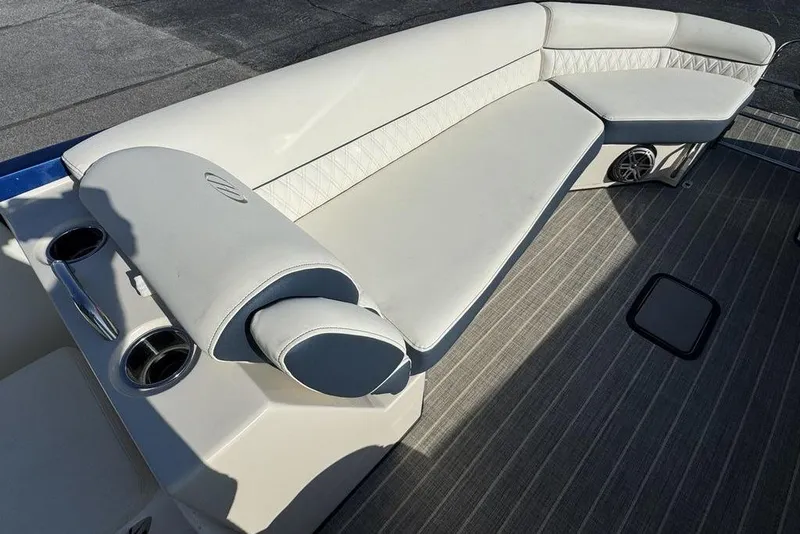 Slide: The Image of Luxurious seating on 2021 Harris Crowne SL 270 Twin Engine boat, featuring cup holders and speakers. - 14