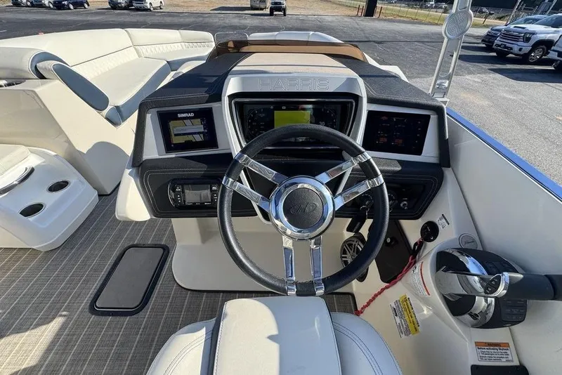 Slide: The Image of 2021 Harris Crowne SL 270 Twin Engine boat dashboard with steering wheel and controls. - 20