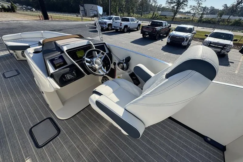 Slide: The Image of 2021 Harris Crowne SL 270 Twin Engine boat cockpit with luxury seating and modern controls. - 21
