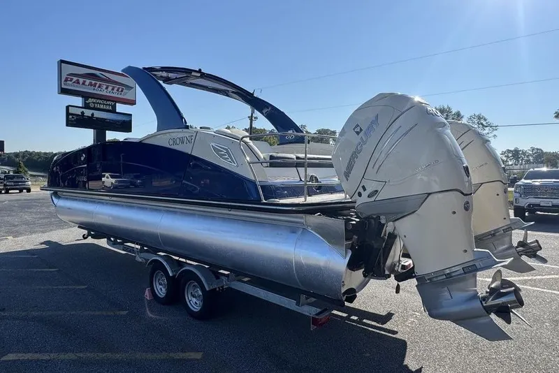 Slide: The Image of 2021 Harris Crowne SL 270 Twin Engine pontoon boat on trailer, displayed outdoors. - 4