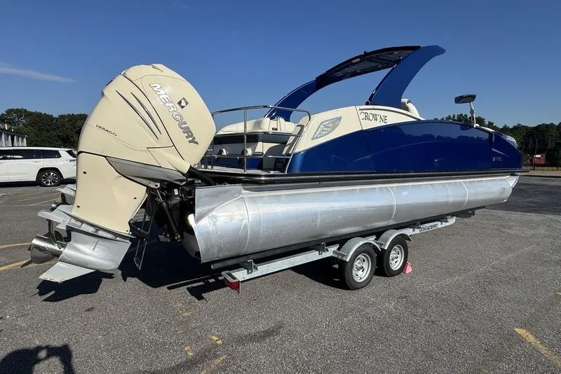 Slide: The Image of 2021 Harris Crowne SL 270 Twin Engine pontoon boat on trailer, featuring Mercury Verado engines. - 5