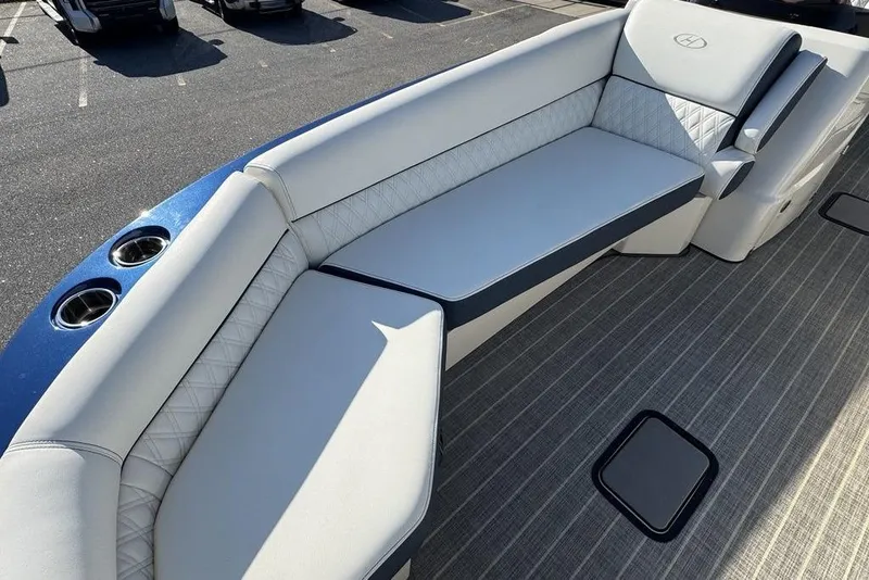Slide: The Image of Luxurious seating on 2021 Harris Crowne SL 270 Twin Engine boat, featuring elegant upholstery and cup holders. - 7