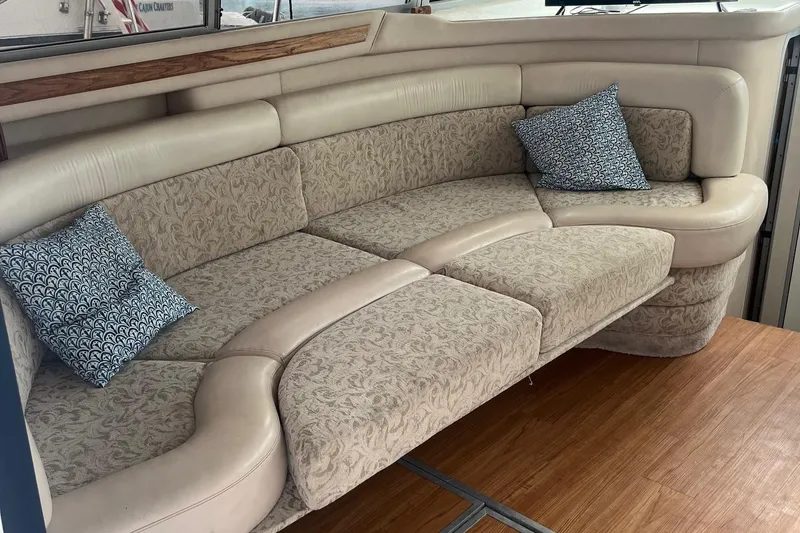 Slide: The Image of Luxurious interior seating of 1996 Sea Ray 370 Sedan Bridge with patterned cushions. - 12