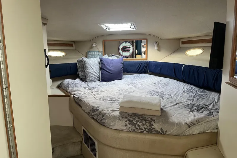 Slide: The Image of Cozy cabin interior of 1996 Sea Ray 370 Sedan Bridge with bed and pillows. - 6