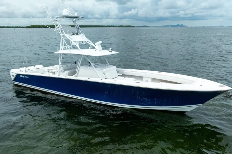 Slide: The Image of 2016 SeaHunter 45 boat with blue hull on open water under cloudy sky. - 12