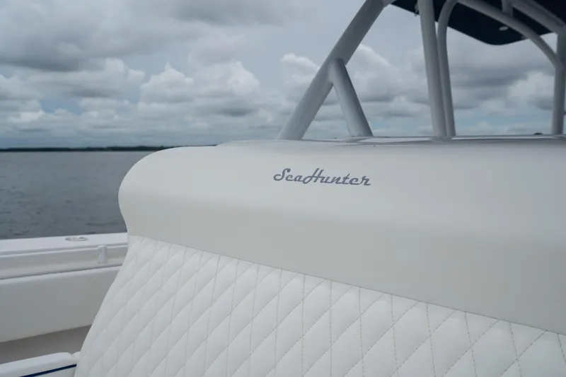 Slide: The Image of 2016 SeaHunter 45 boat with quilted white seating, cloudy sky background. - 16