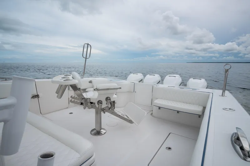 Slide: The Image of 2016 SeaHunter 45 boat with fishing chair, ocean view, and multiple outboard engines. - 18