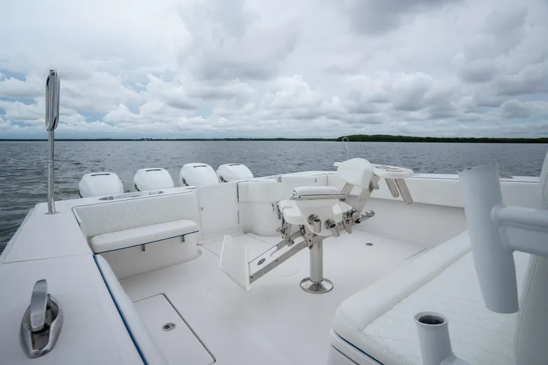 Slide: The Image of 2016 SeaHunter 45 boat interior with fishing chair and multiple outboard engines on a cloudy day. - 19