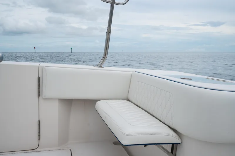 Slide: The Image of 2016 SeaHunter 45 boat interior with white seating, ocean view in background. - 23