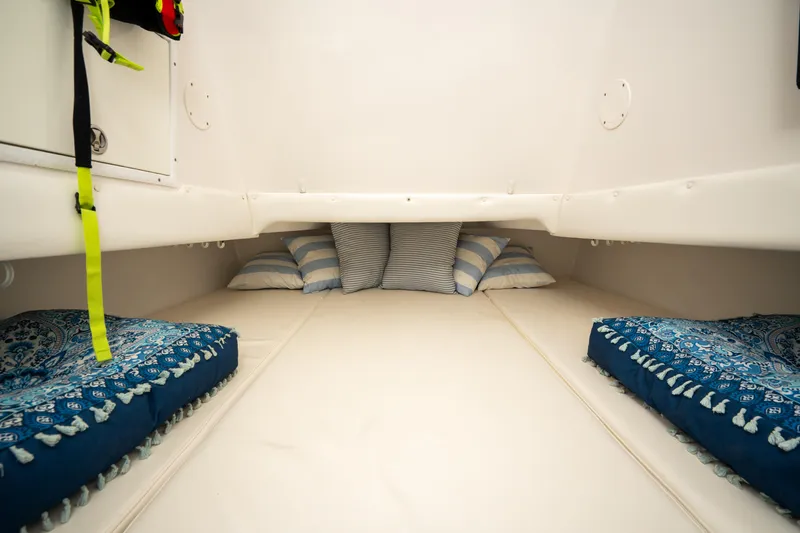 Slide: The Image of Interior cabin of 2016 SeaHunter 45 boat with cozy bedding and striped pillows. - 30