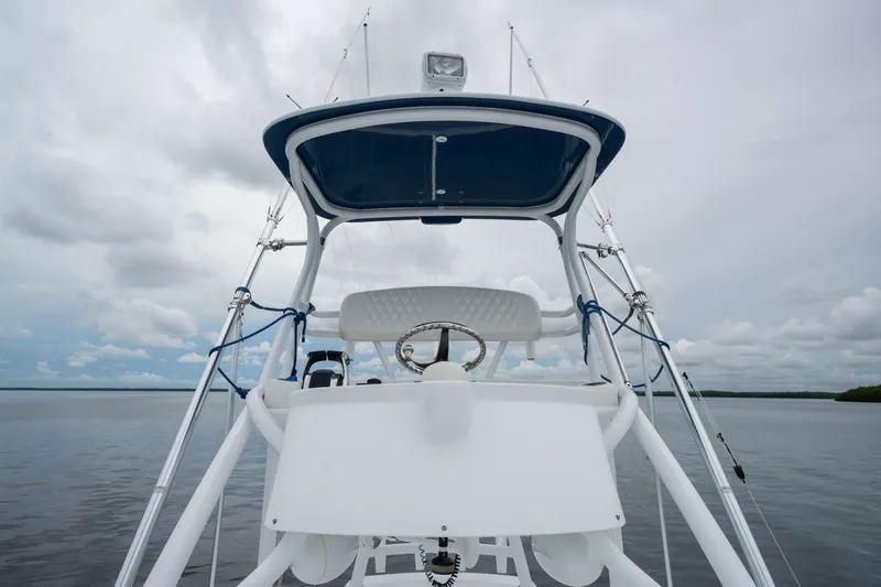 Slide: The Image of 2016 SeaHunter 45 boat helm with steering wheel, set against a cloudy sky and calm waters. - 36