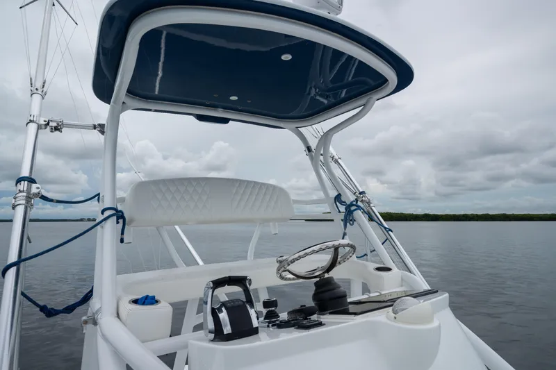 Slide: The Image of Helm of 2016 SeaHunter 45 boat with steering wheel and controls, on calm water. - 37