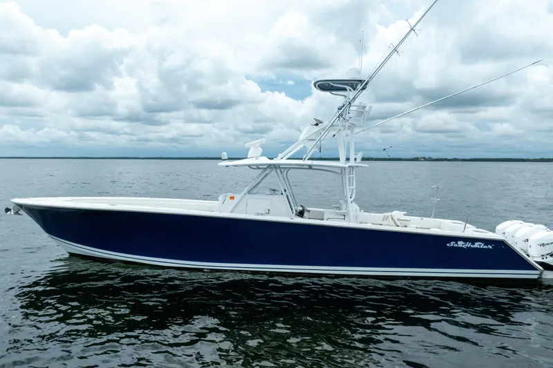 Slide: The Image of 2016 SeaHunter 45 boat on calm water under cloudy sky. - 4