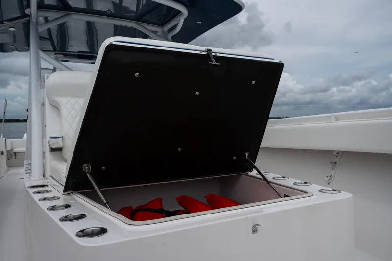 Slide: The Image of Open storage compartment on 2016 SeaHunter 45 boat, containing red life jackets. - 41
