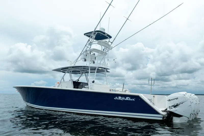 Slide: The Image of 2016 SeaHunter 45 boat with multiple outboard engines on a cloudy day. - 8
