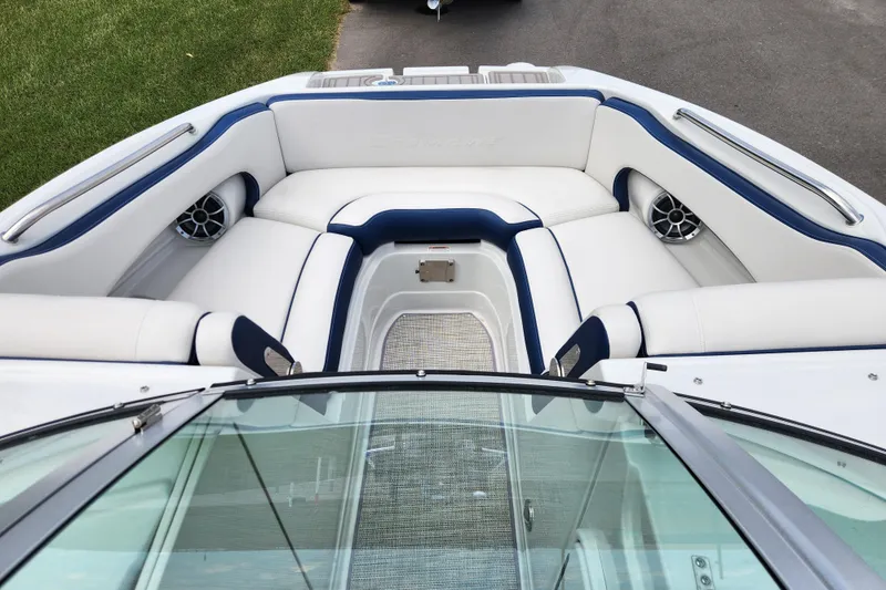 Slide: The Image of 2024 Crownline Eclipse E240 XS boat interior with white and blue seating. - 10