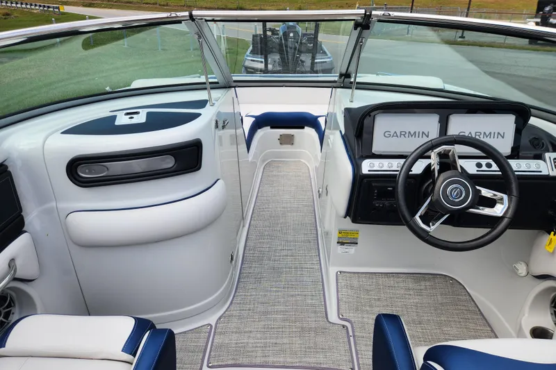 Slide: The Image of 2024 Crownline Eclipse E240 XS boat interior with Garmin displays and modern steering wheel. - 11