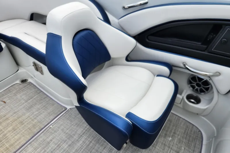 Slide: The Image of 2024 Crownline Eclipse E240 XS boat interior with blue and white seating. - 13
