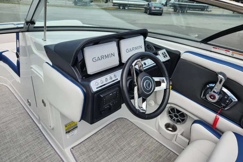 Slide: The Image of 2024 Crownline Eclipse E240 XS boat dashboard with Garmin displays and modern steering wheel. - 15