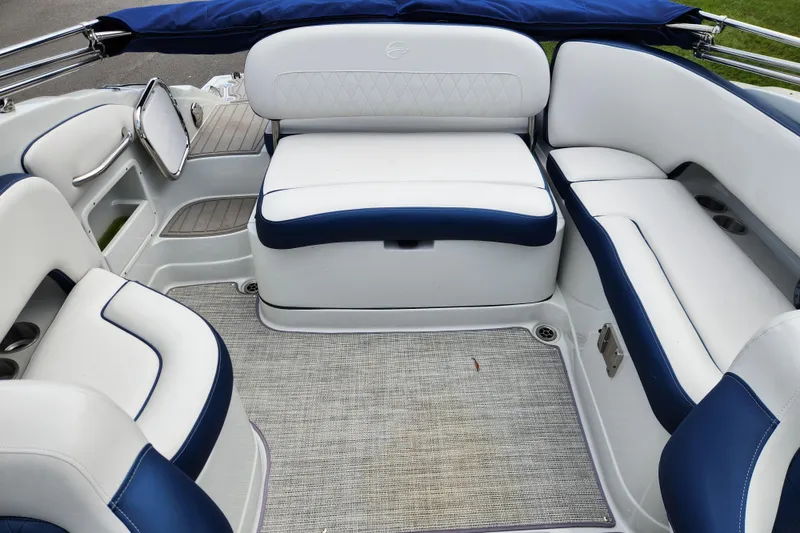Slide: The Image of 2024 Crownline Eclipse E240 XS boat interior with white and blue seating. - 16