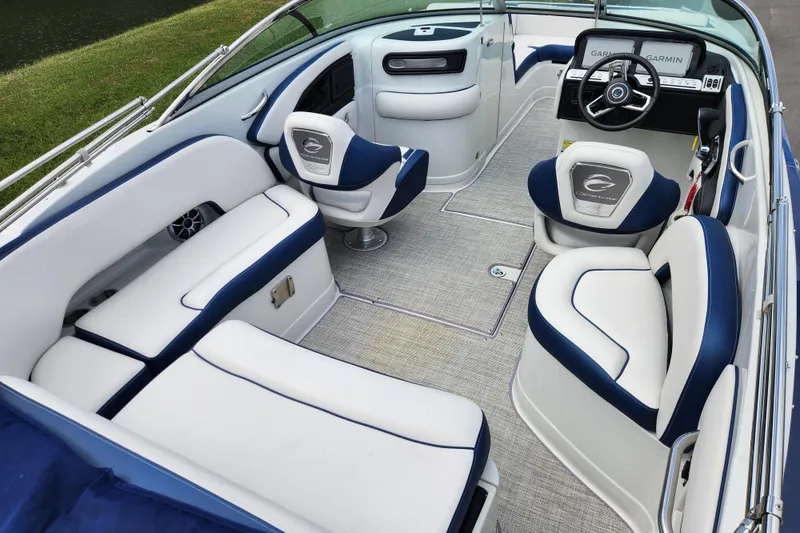 Slide: The Image of 2024 Crownline Eclipse E240 XS boat interior with plush seating and modern dashboard. - 17