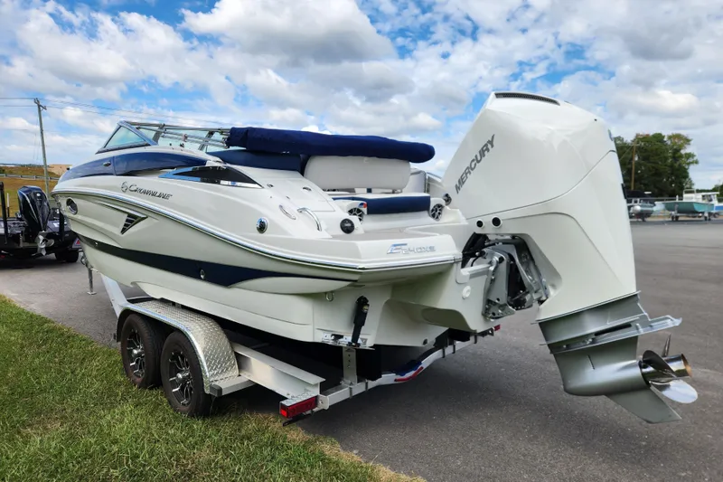 Slide: The Image of 2024 Crownline Eclipse E240 XS boat on trailer, featuring Mercury outboard motor. - 4