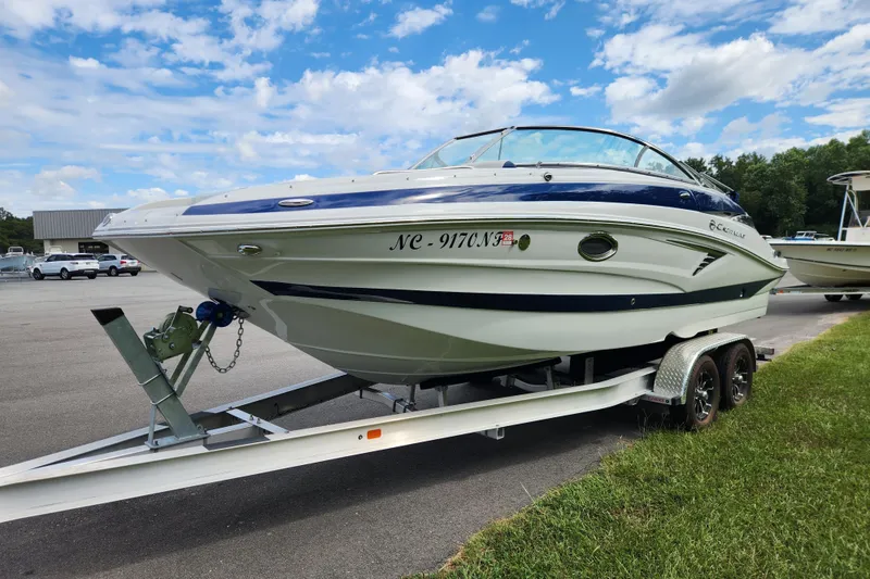 Slide: The Image of 2024 Crownline Eclipse E240 XS boat on trailer under blue sky. - 7