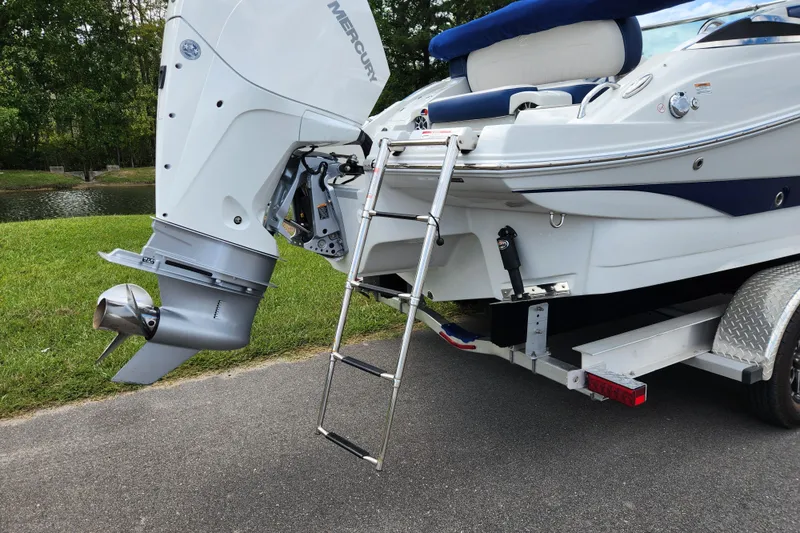 Slide: The Image of 2024 Crownline Eclipse E240 XS boat with Mercury outboard motor and ladder. - 8