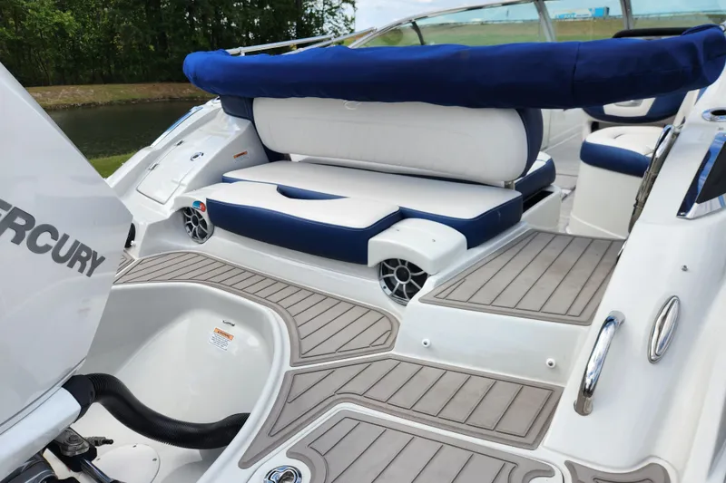 Slide: The Image of 2024 Crownline Eclipse E240 XS boat interior with seating and Mercury engine. - 9
