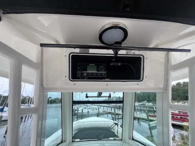 Slide: The Image of Boston Whaler 280 Outrage 2020 helm with radio and marina view. - 19