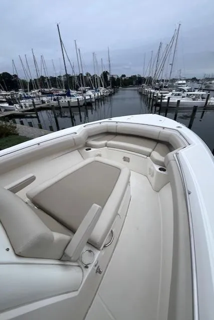 Slide: The Image of 2020 Boston Whaler 280 Outrage boat with spacious seating in a marina. - 23